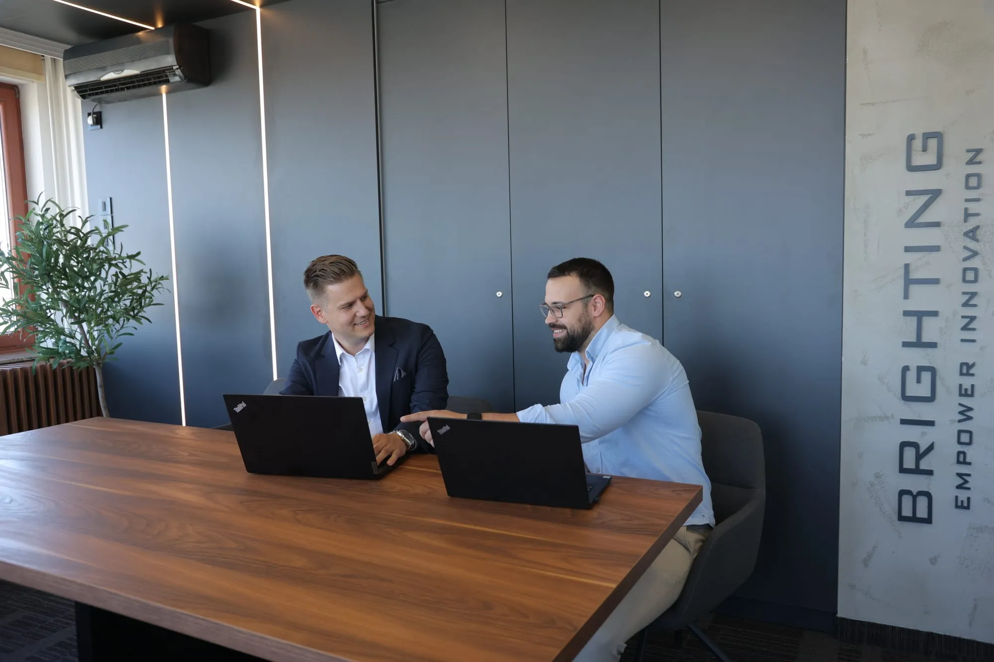 Two Brighting colleagues working together at the Novi Sad office